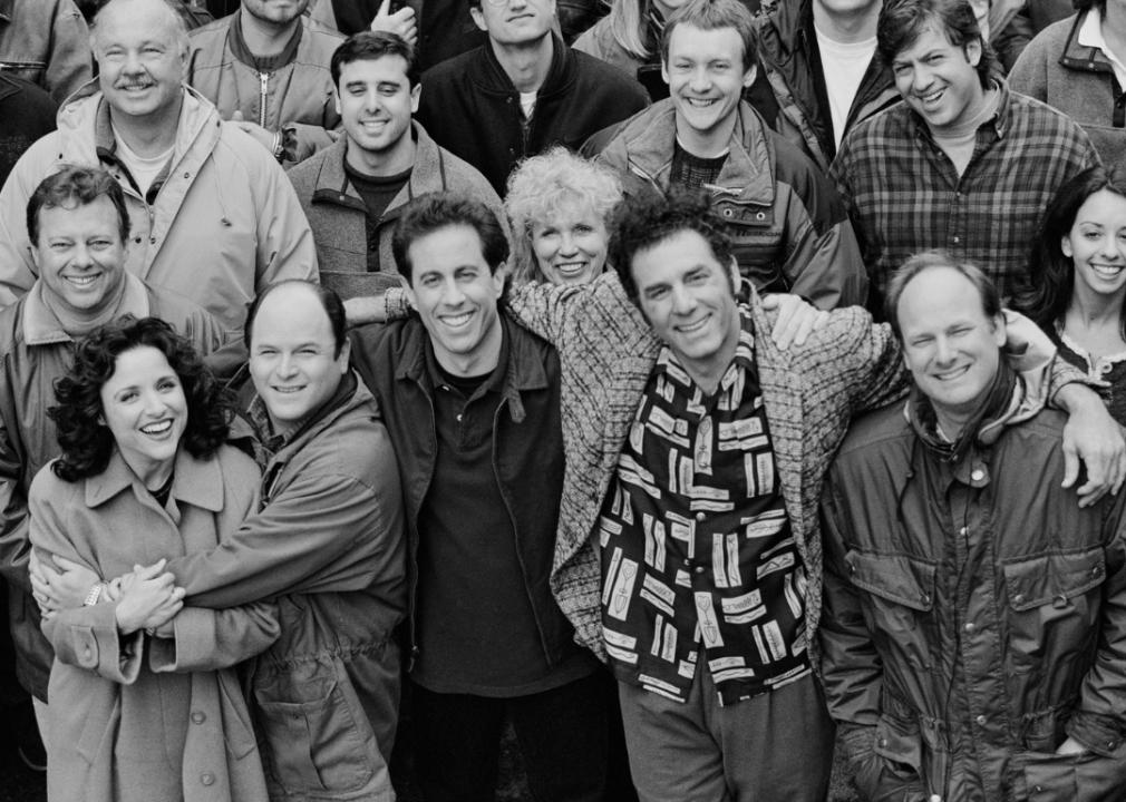 The cast and crew of 'Seinfeld' pose on set.
