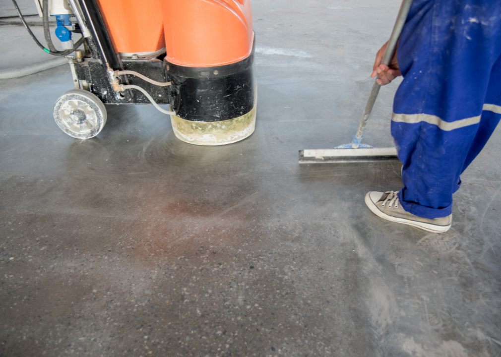 Workers polish a floor.