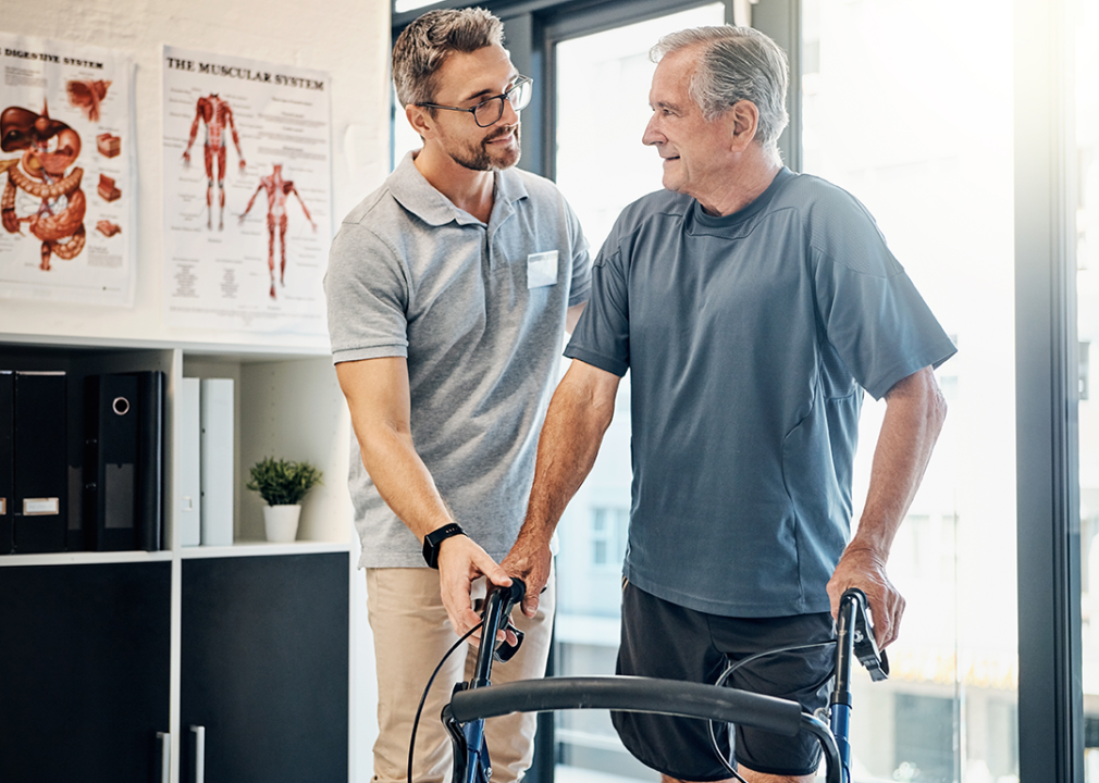 Physical therapist with working with man in office.