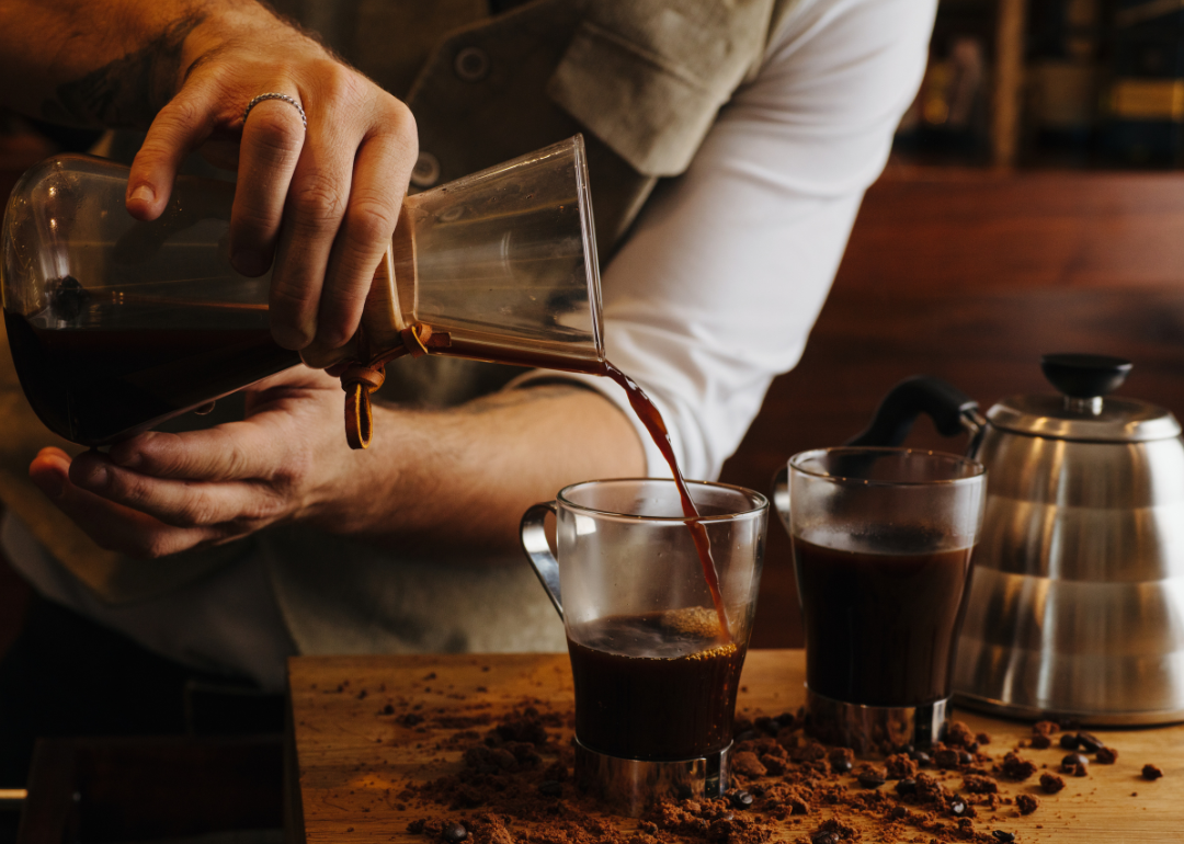 Barista pouring drip coffee.