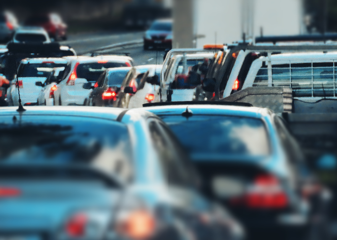 Cars stopped in heavy traffic on highway.