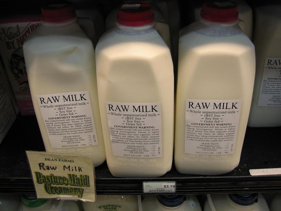 Rows of raw milk in a refrigerator.