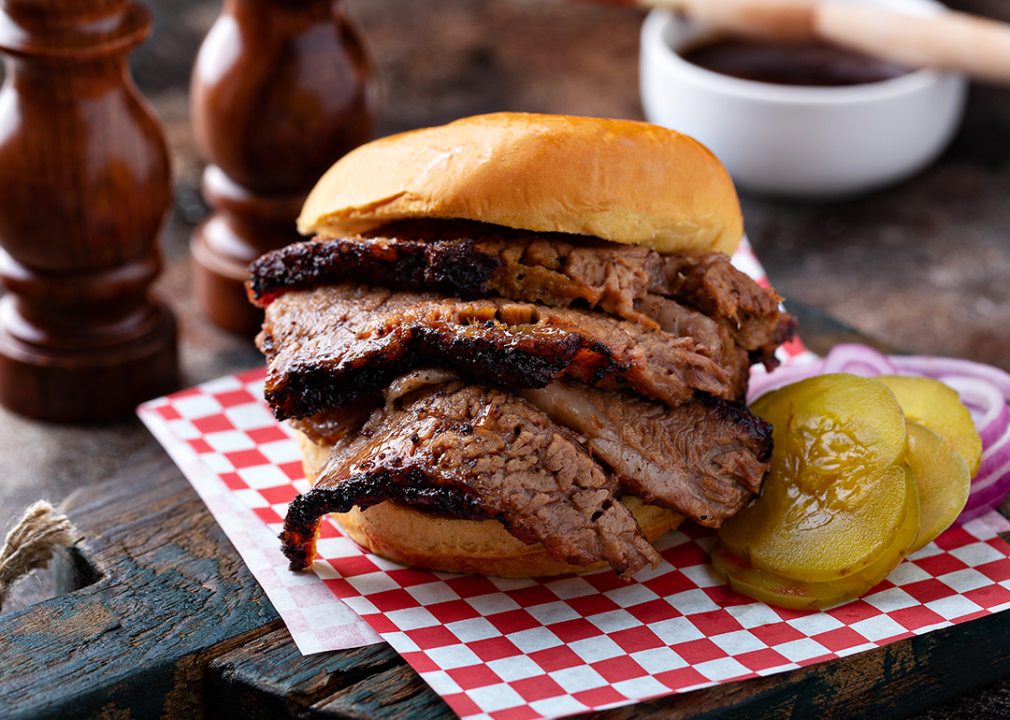 Smoked barbecue beef brisket sandwich with pickles.