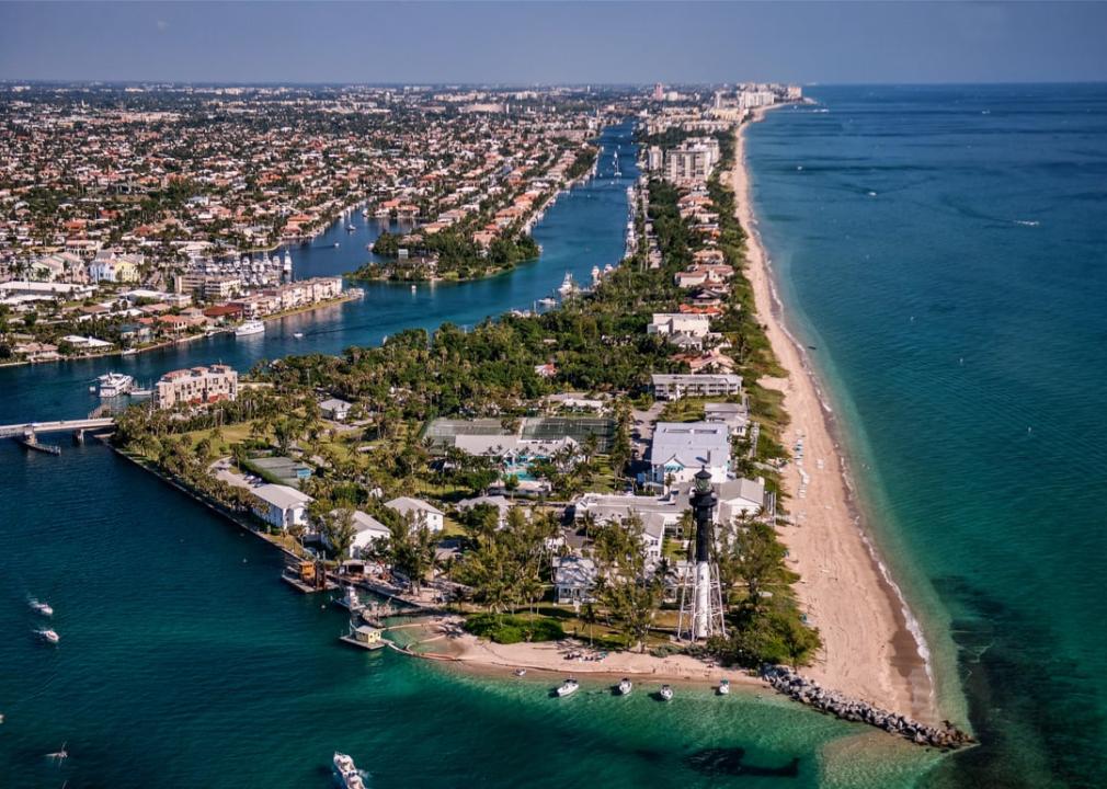 Aerial view of lighthouse and boating inlet.