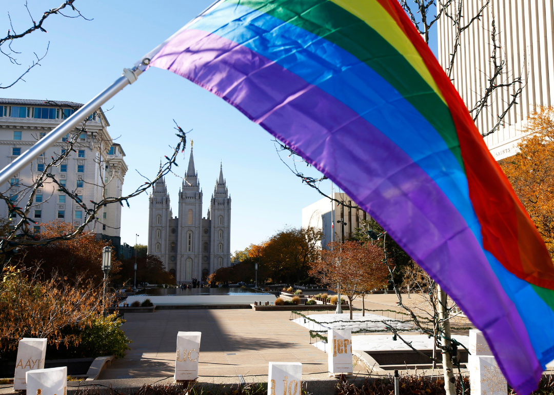 A pride flag flies in front of the Historic Mormon Temple in Salt Lake City Utah