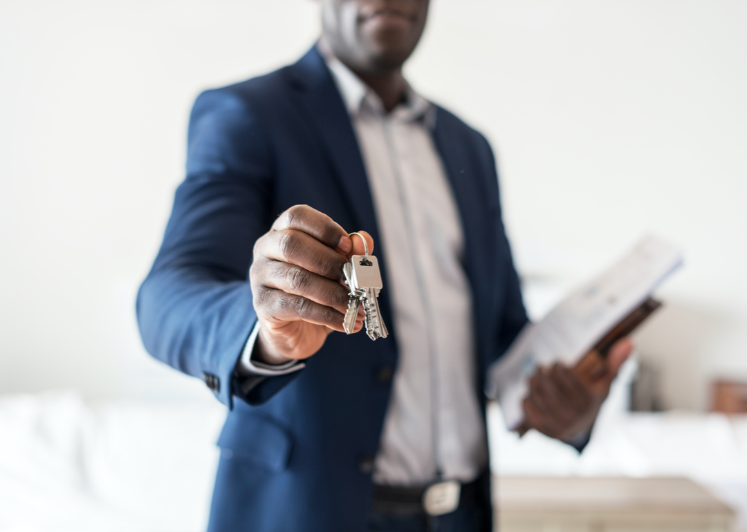 A real estate agent handing over keys.