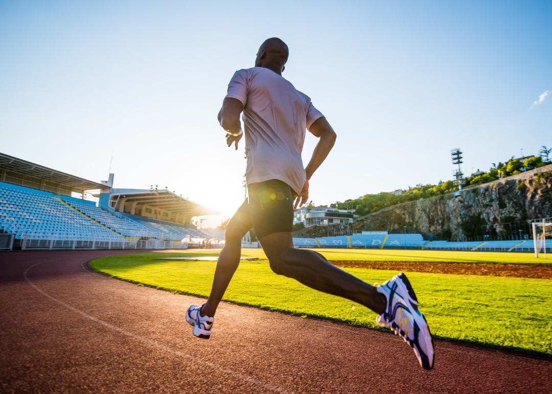Male athlete running on track.