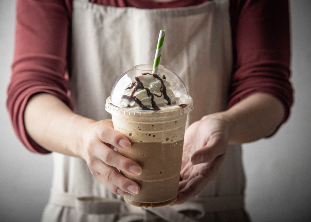 Barista serving iced mocaccino.