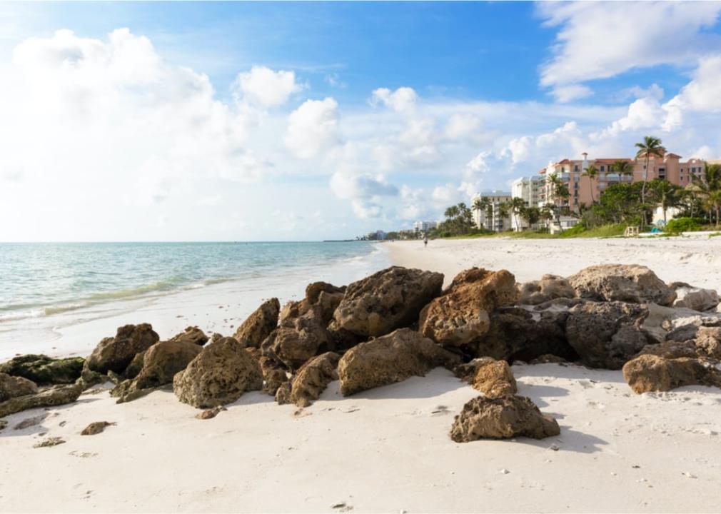 White sand beaches with buildings in background in Naples.