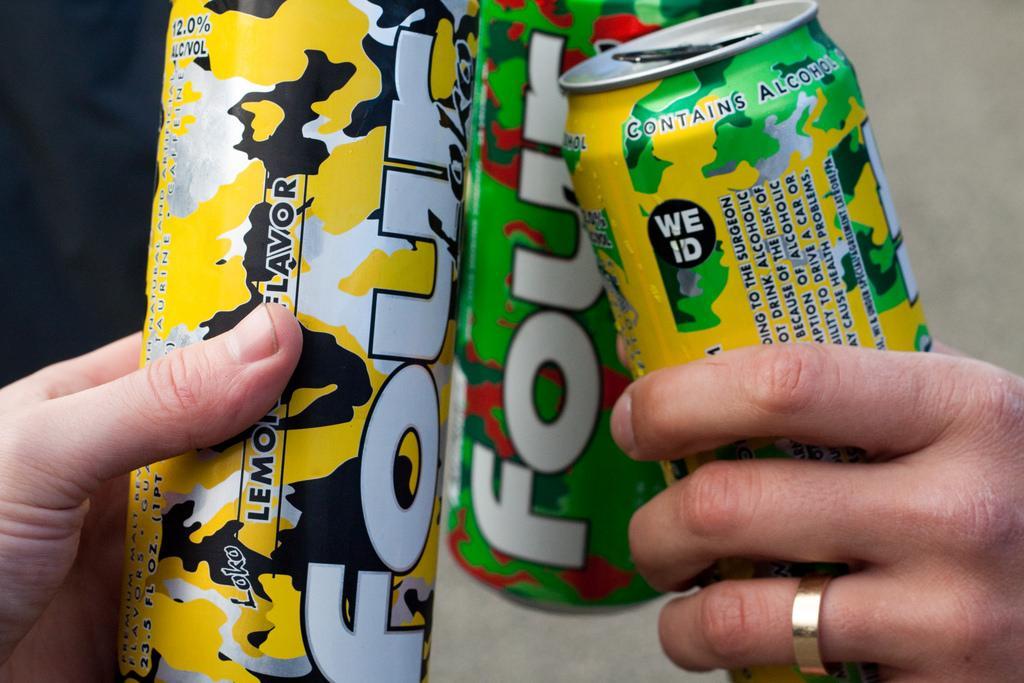 People clinking Four Loko cans together.