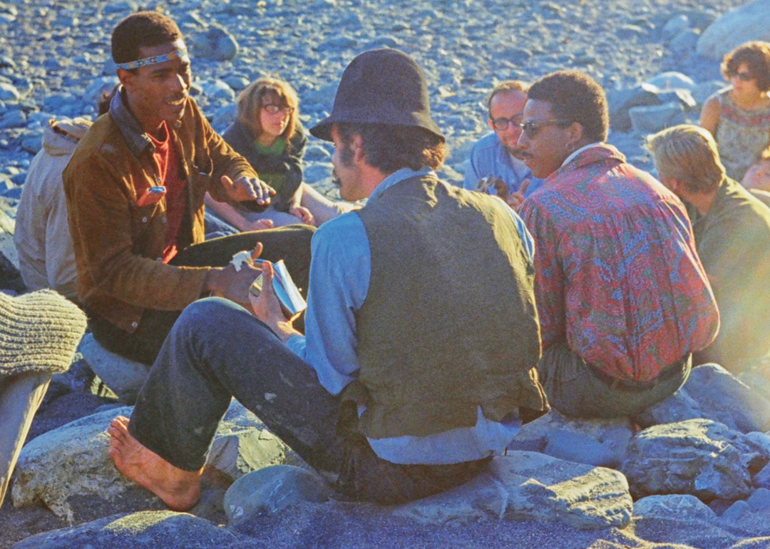 Hippies gathering at sunset on the beach.