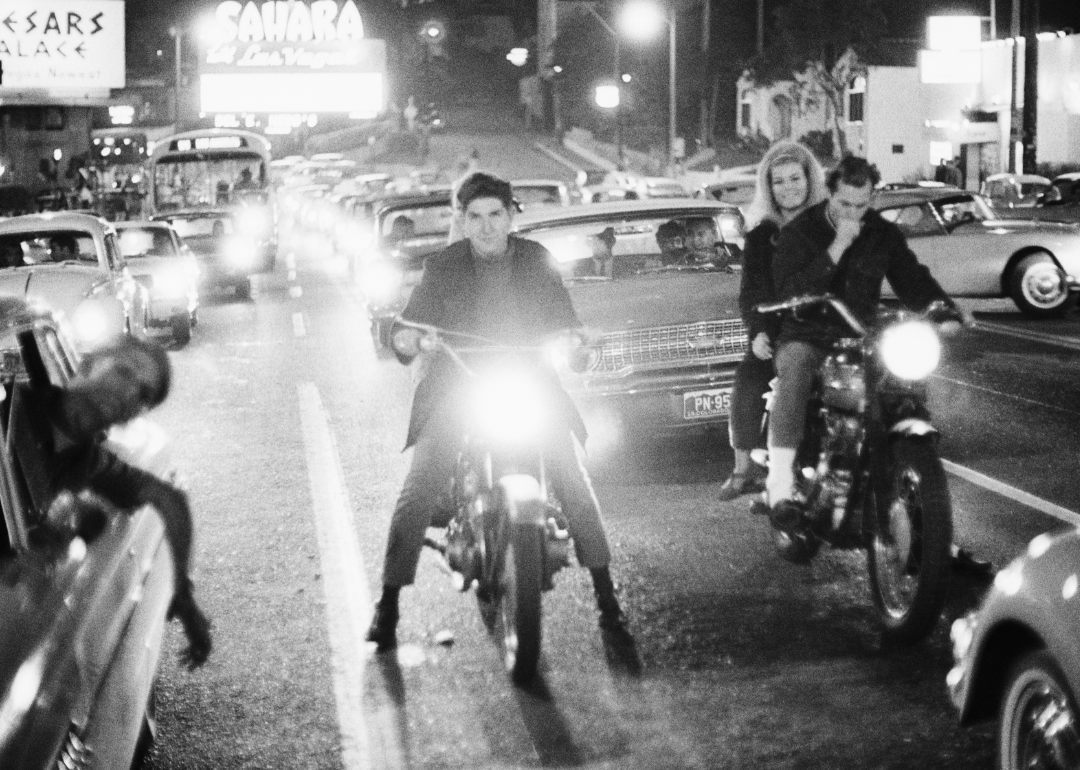 Teenagers cruise the Las Vegas Strip on motorcycles and in cars at night in the 1960s.