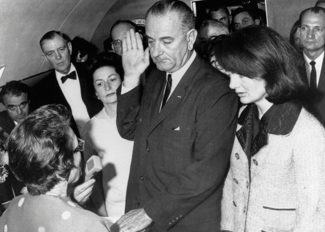 Lyndon B. Johnson is sworn in to the office of the Presidency aboard Air Force One in Dallas.
