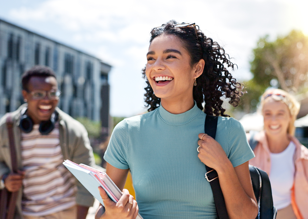 Smiling college students walking on campus.