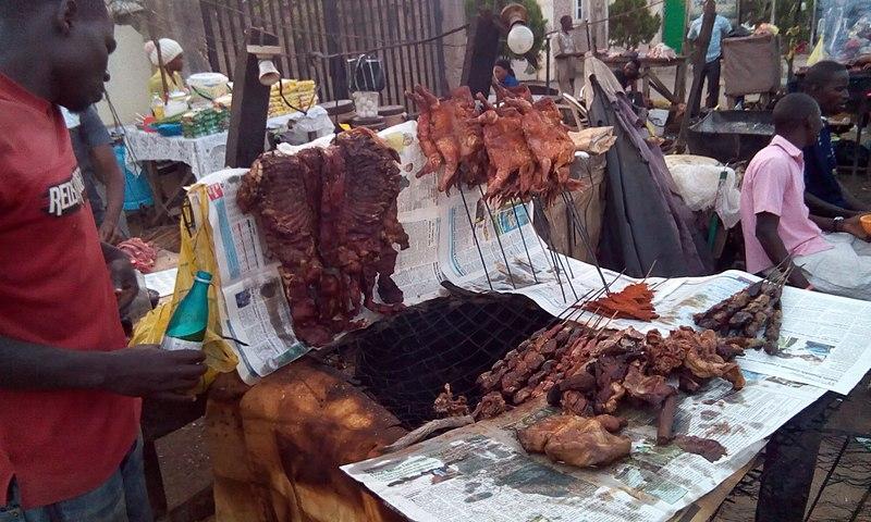 Cooks preparing bush meat for sale at market.