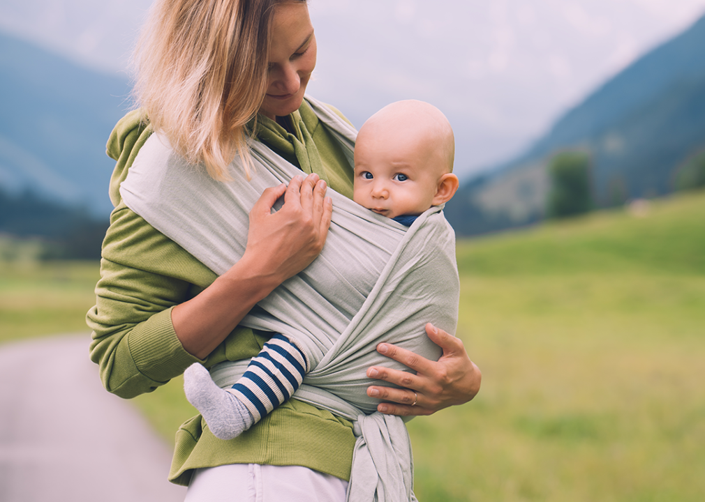 Mother carrying baby on trail.