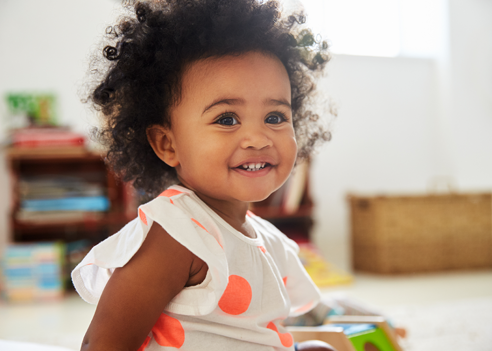 Happy girl playing with toys.