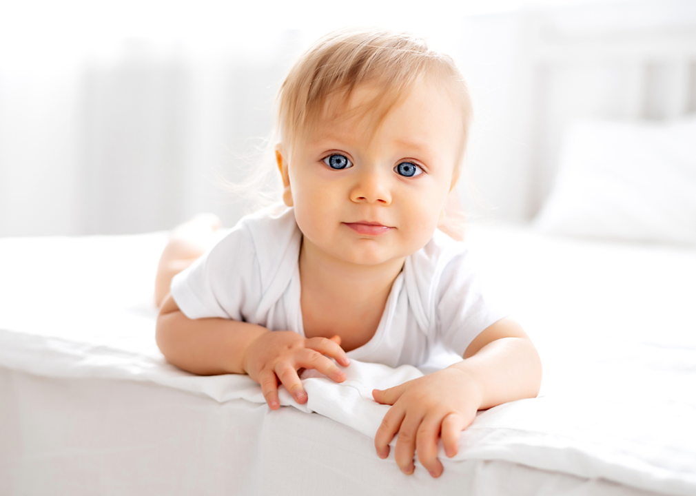 Portrait of baby with blue eyes looking at camera.