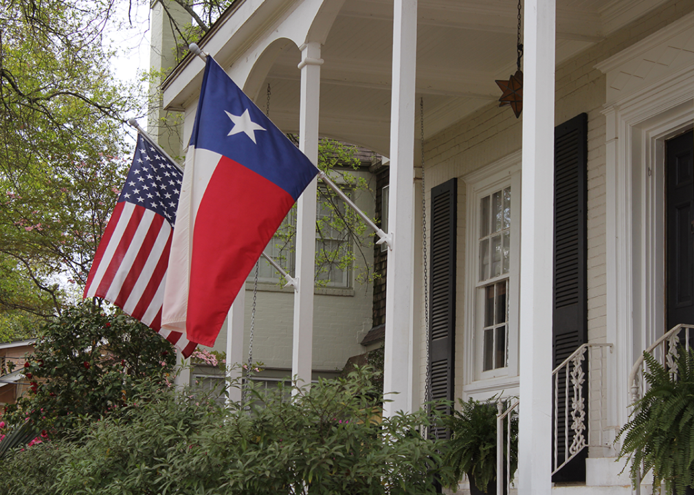 Historic home with Texas and American Flags.