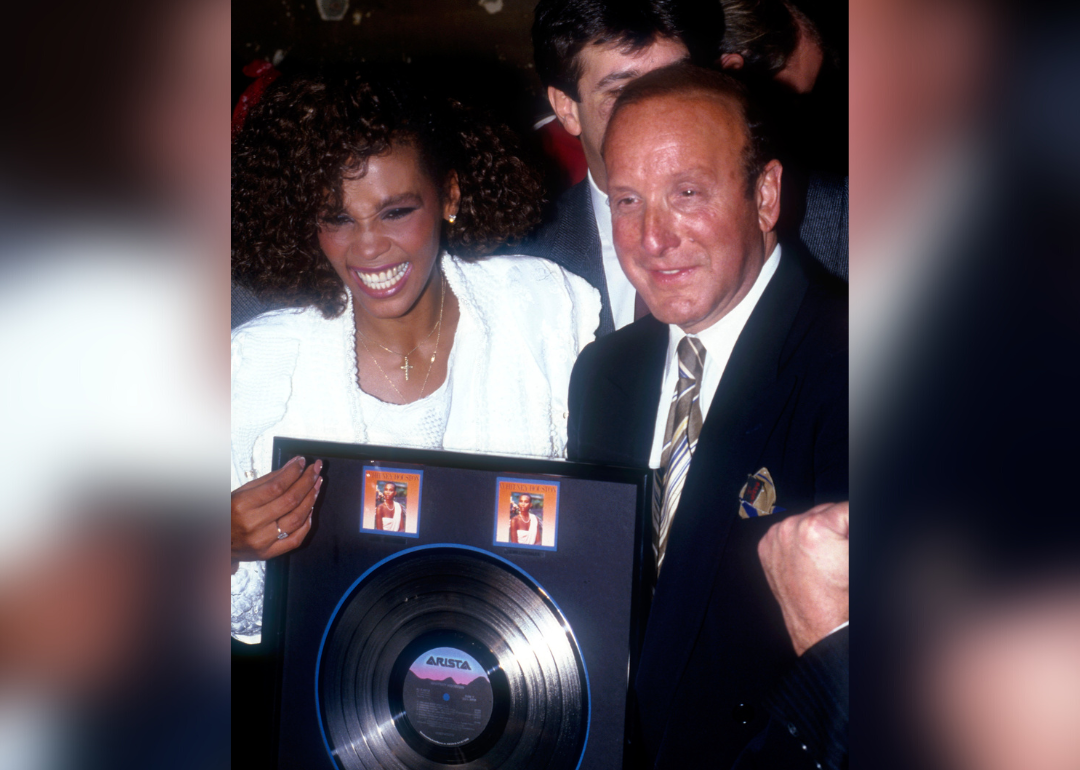 Whitney Houston and Clive Davis celebrate sales of debut album.