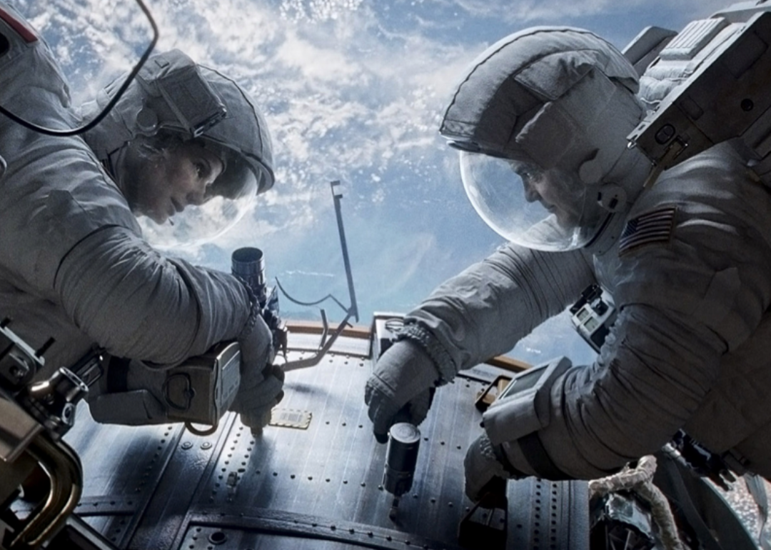 Actors Sandra Bullock and George Clooney in a scene from ‘Gravity.'