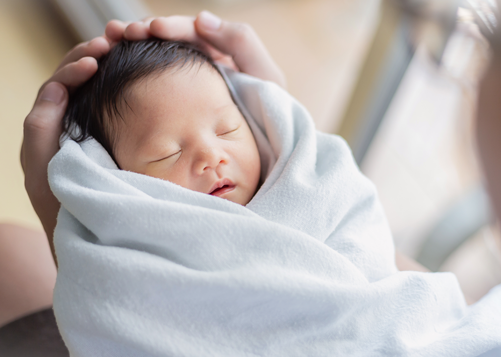 Father holding newborn.