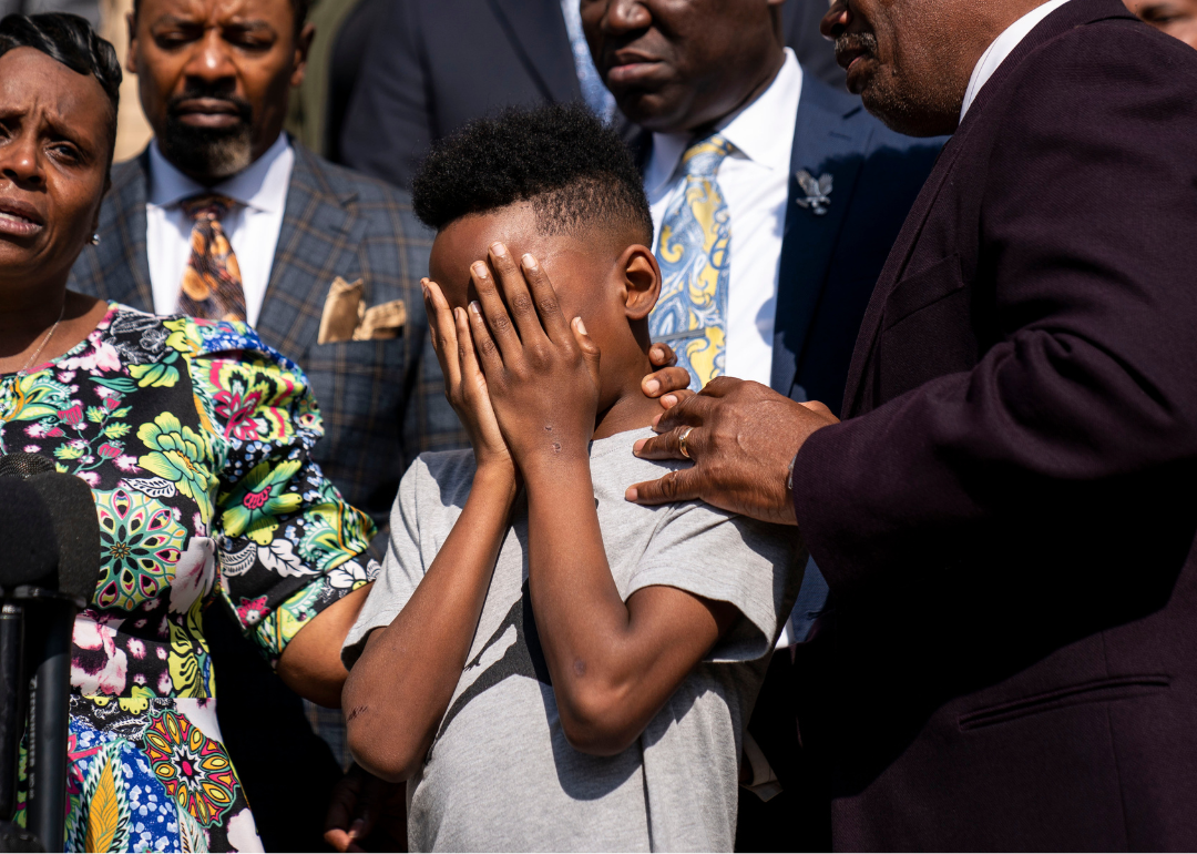 Jacob Patterson, 11, is comforted as his mother speaks during a news conference about the mass shooting in Buffalo New York on. May 19, 2022.