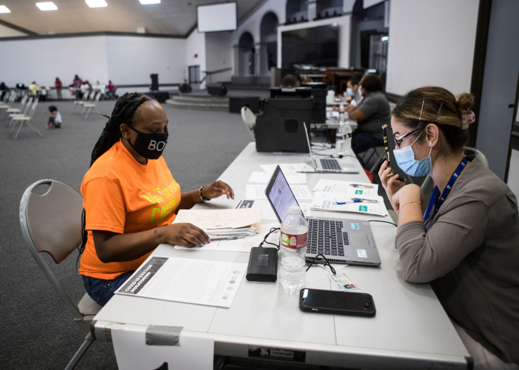 A woman helping someone apply for aid.