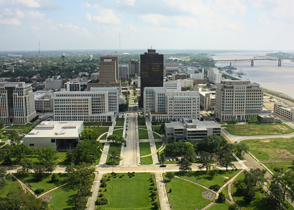 Aerial view of tall skyscrapers with a winding river in the background.