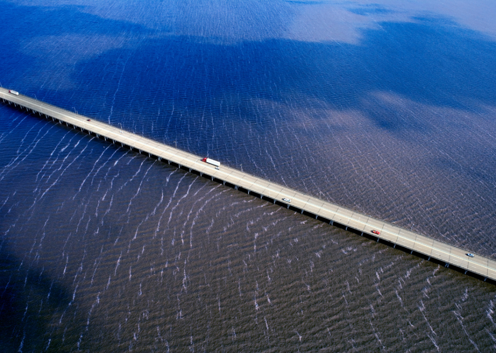 An aerial view of a bridge over a body of water. 
