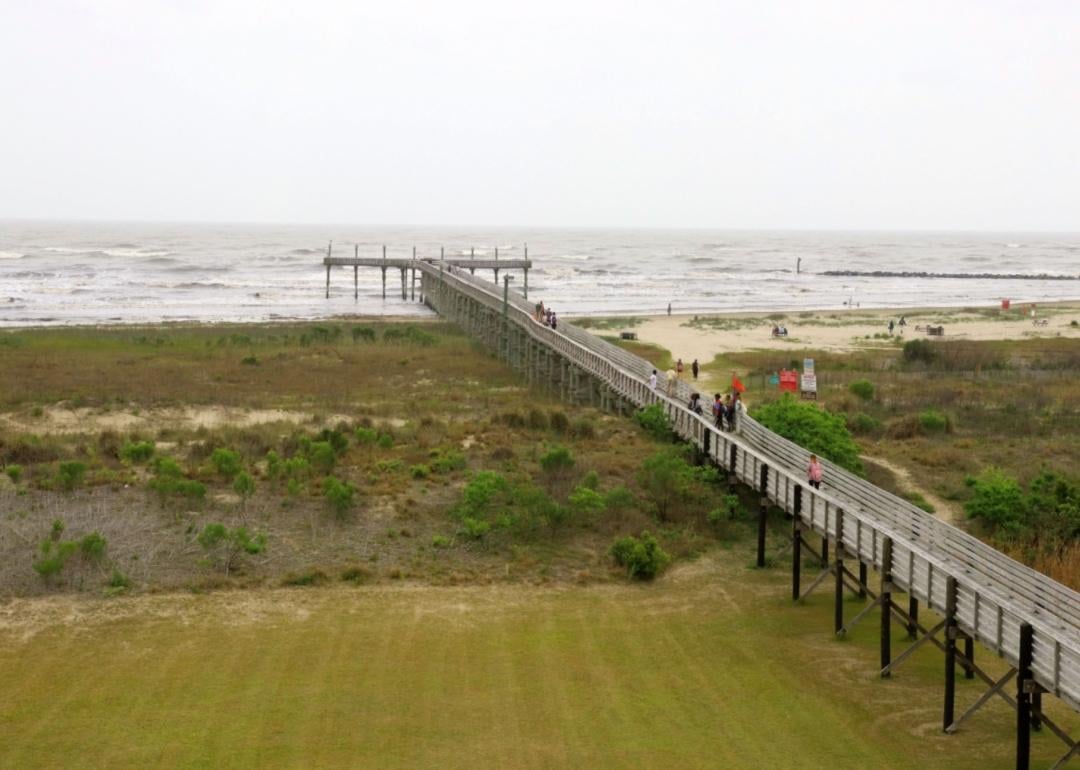 A pier going out to the beach at Grand Isle State Park.