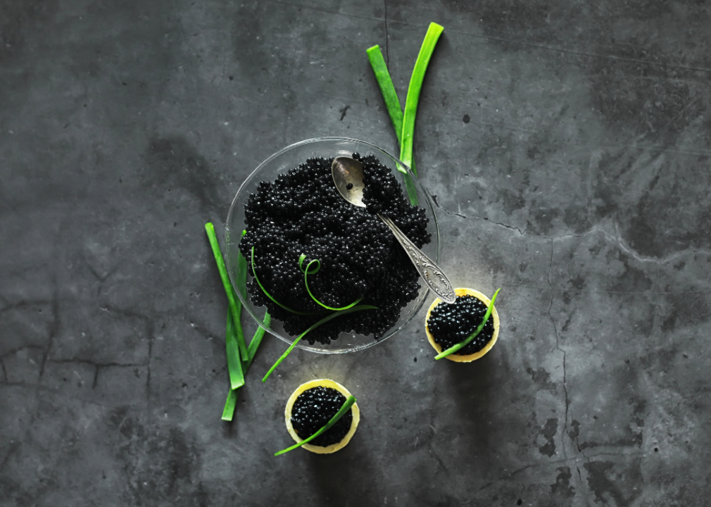 Presentation of Beluga caviar against a stone surface.