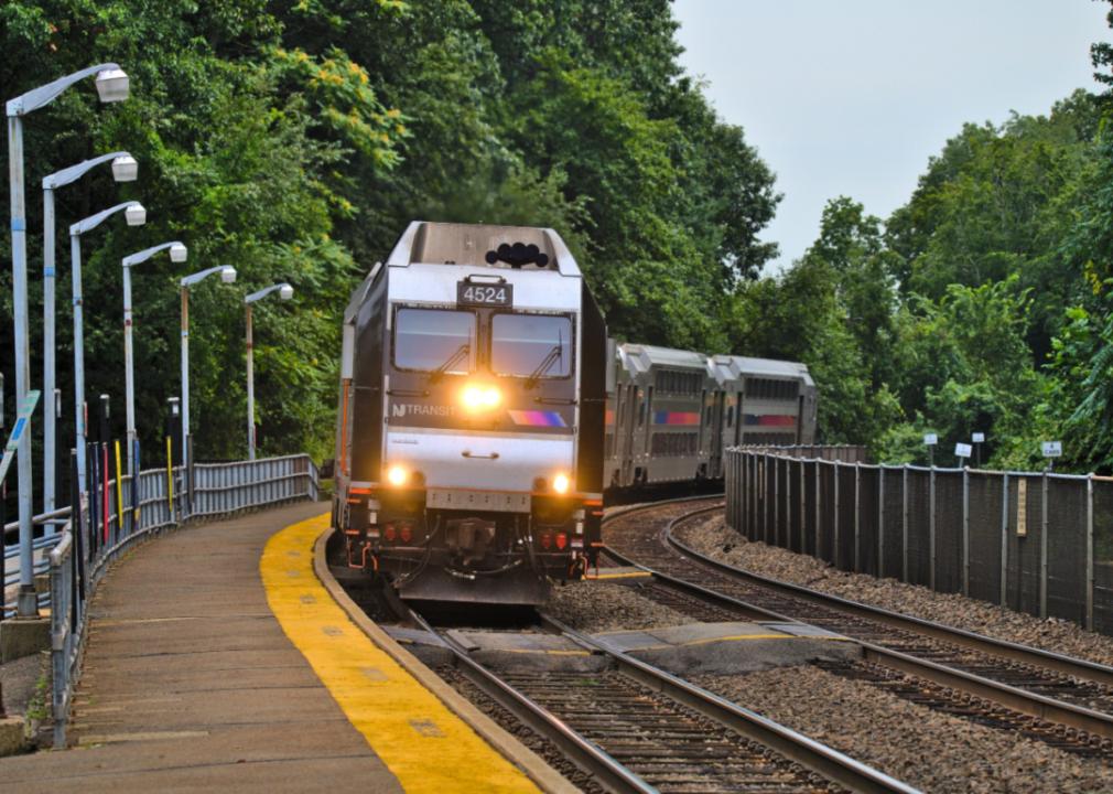 The New Jersey transit train arriving at a station.