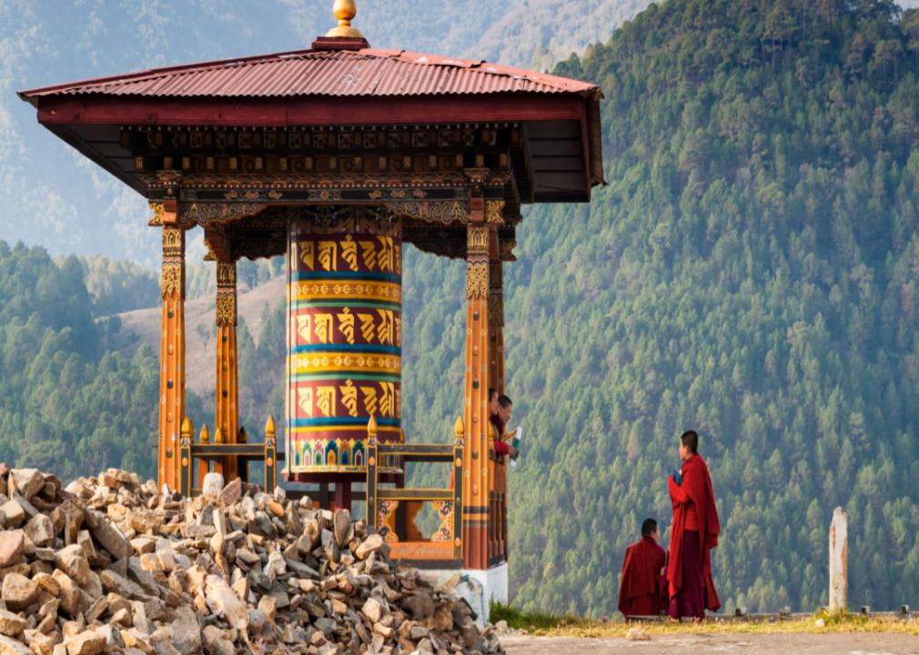 Young women monks of a Buddhist monastery with Himalaya mountains in the background