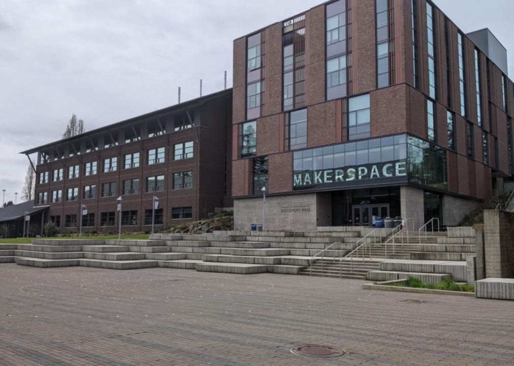 A brown brick building with the words Makerspace and Discovery Hall on it.