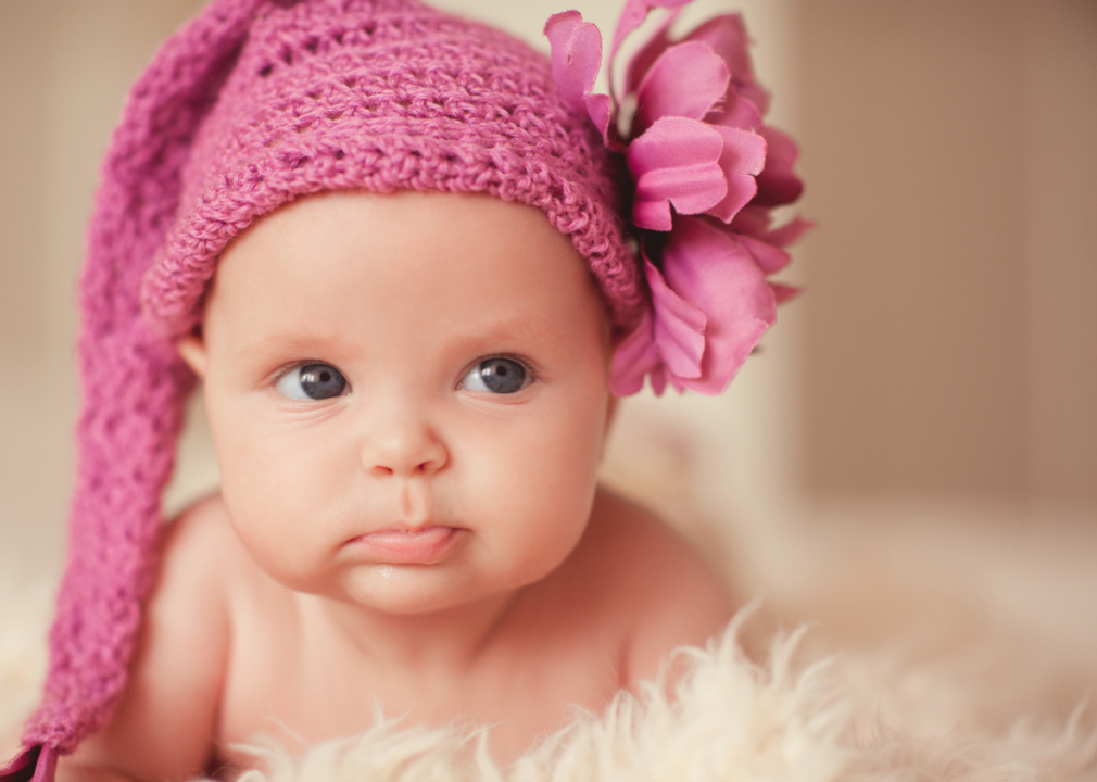A baby girl in a pink hat.