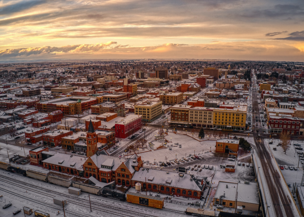 Aerial view of the city under snow at dusk.