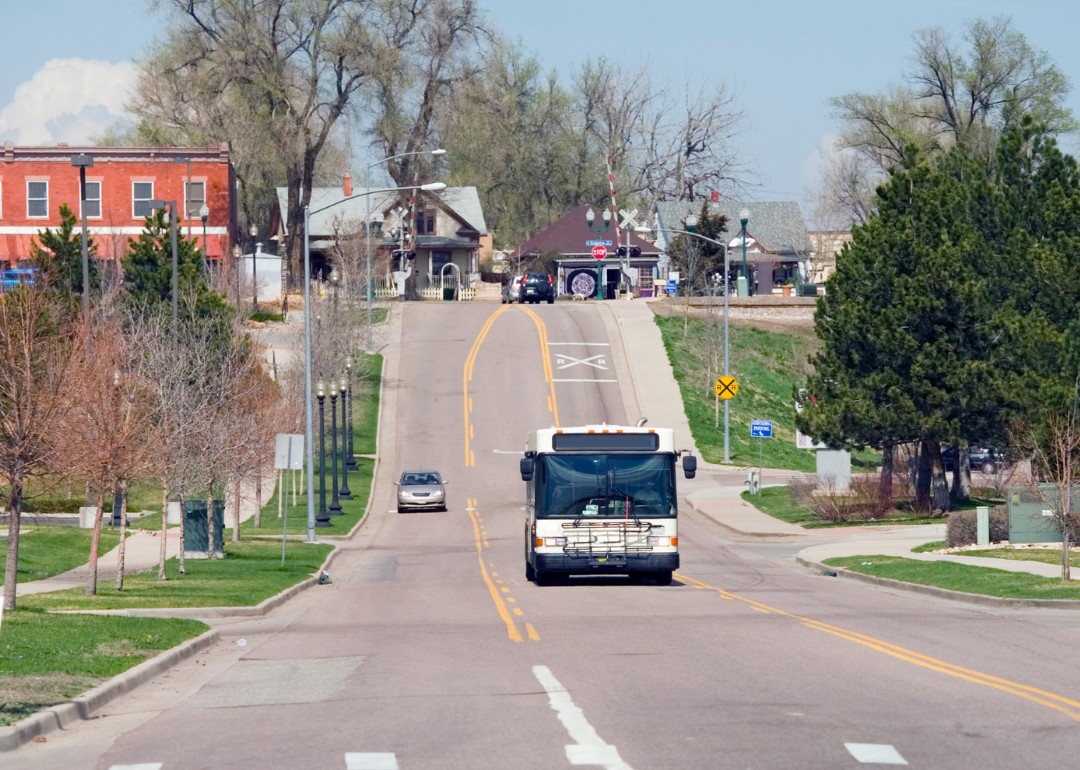 A bus driving down the street in Arvada.