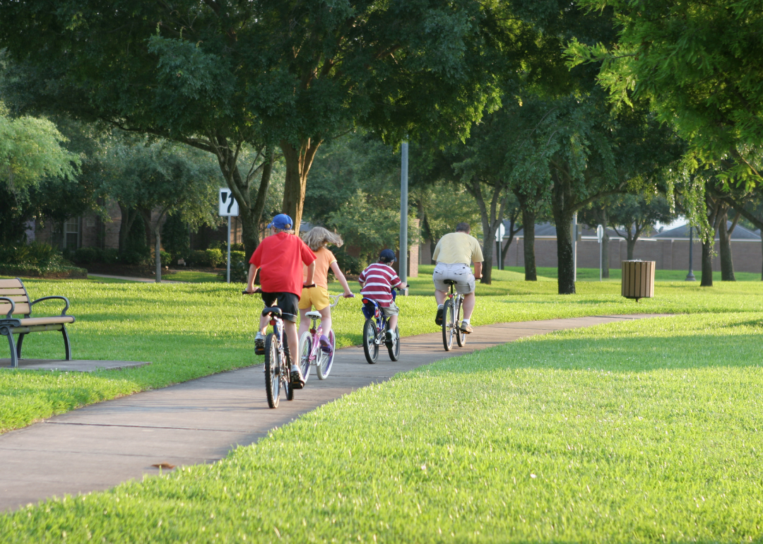 A family biking through a park in Sugar Land.