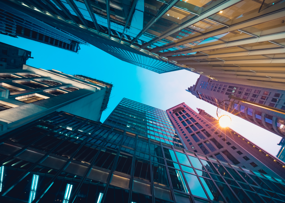 Upward view of tall commercial buildings in a major city.