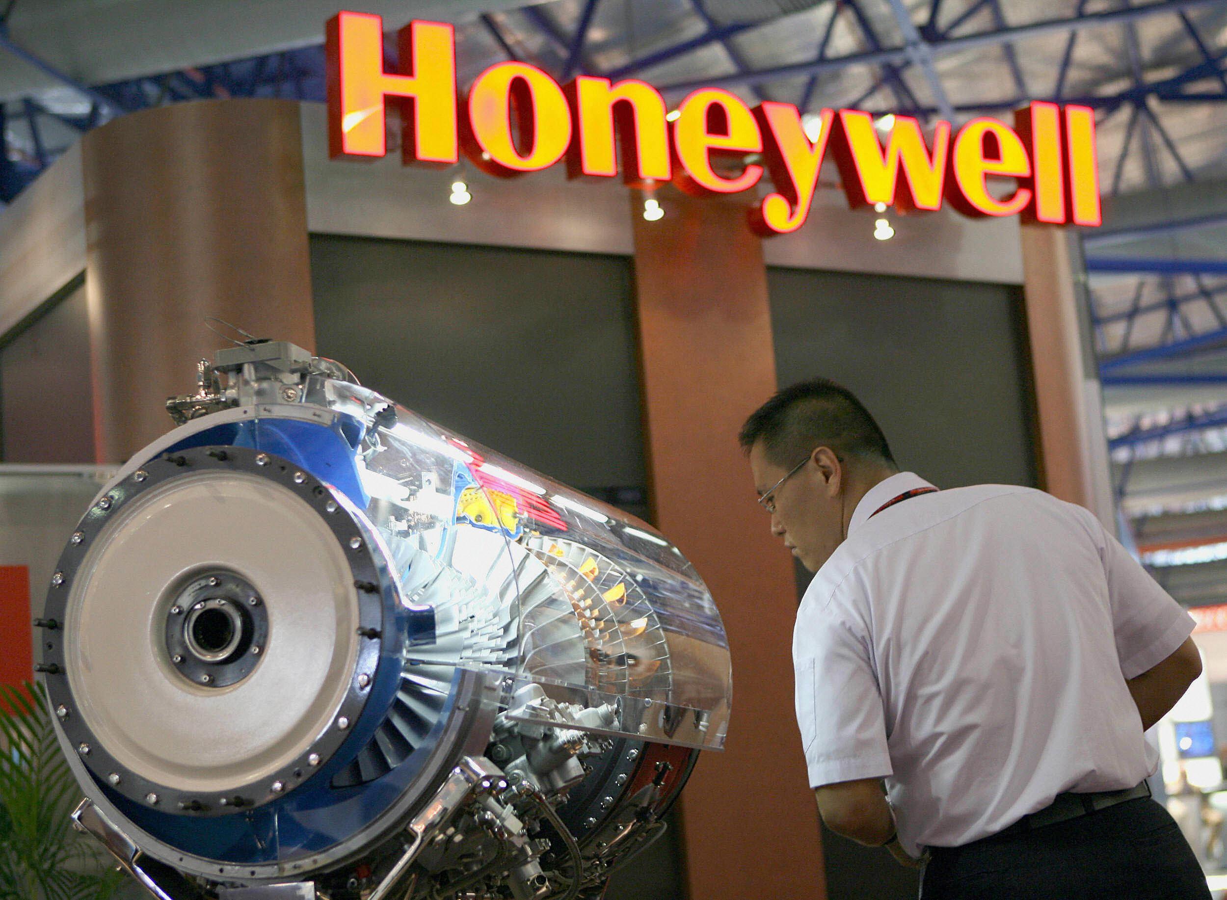 A man viewing a Honeywell aircraft engine on display.