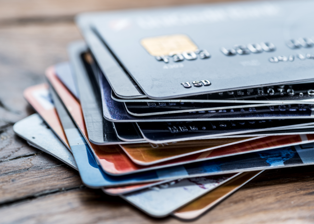A stack of credit cards resting on a wooden table