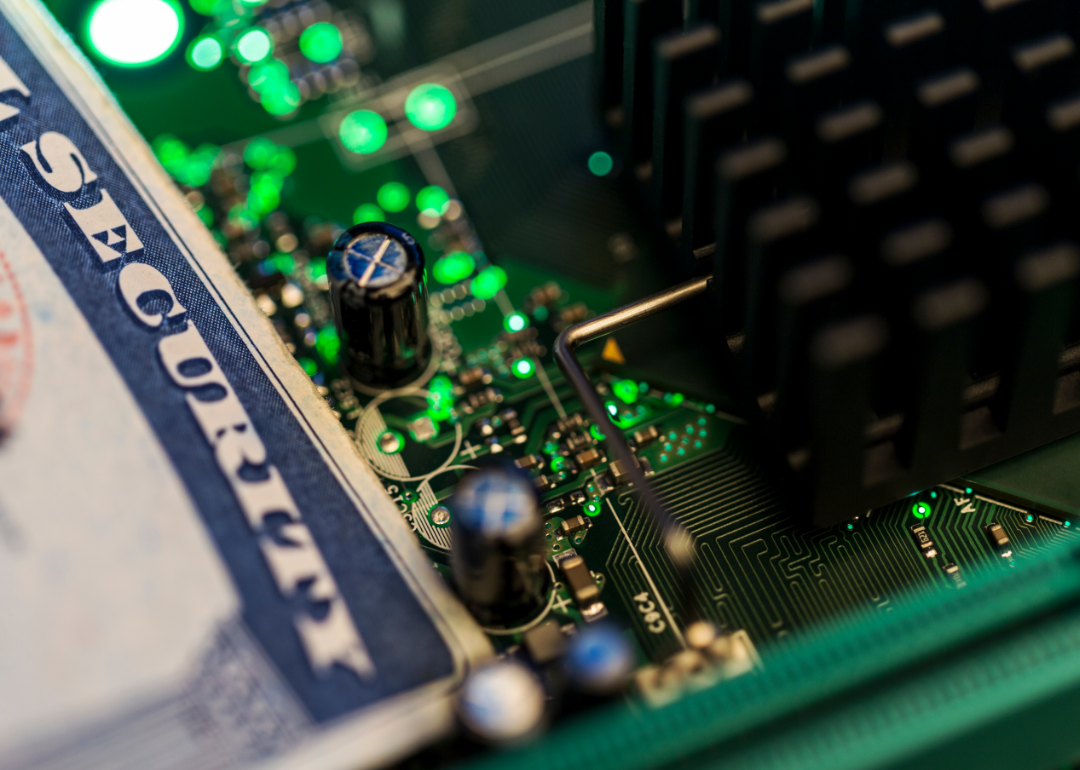 A social security card rests atop a digital display