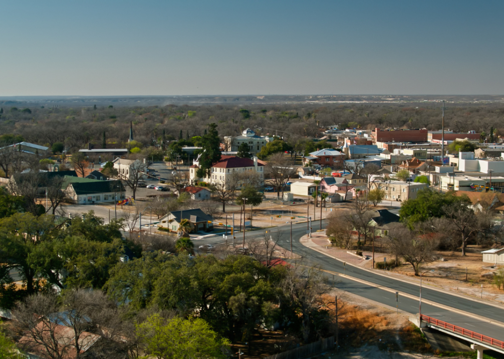 An aerial view of a small town surrounded by trees. 