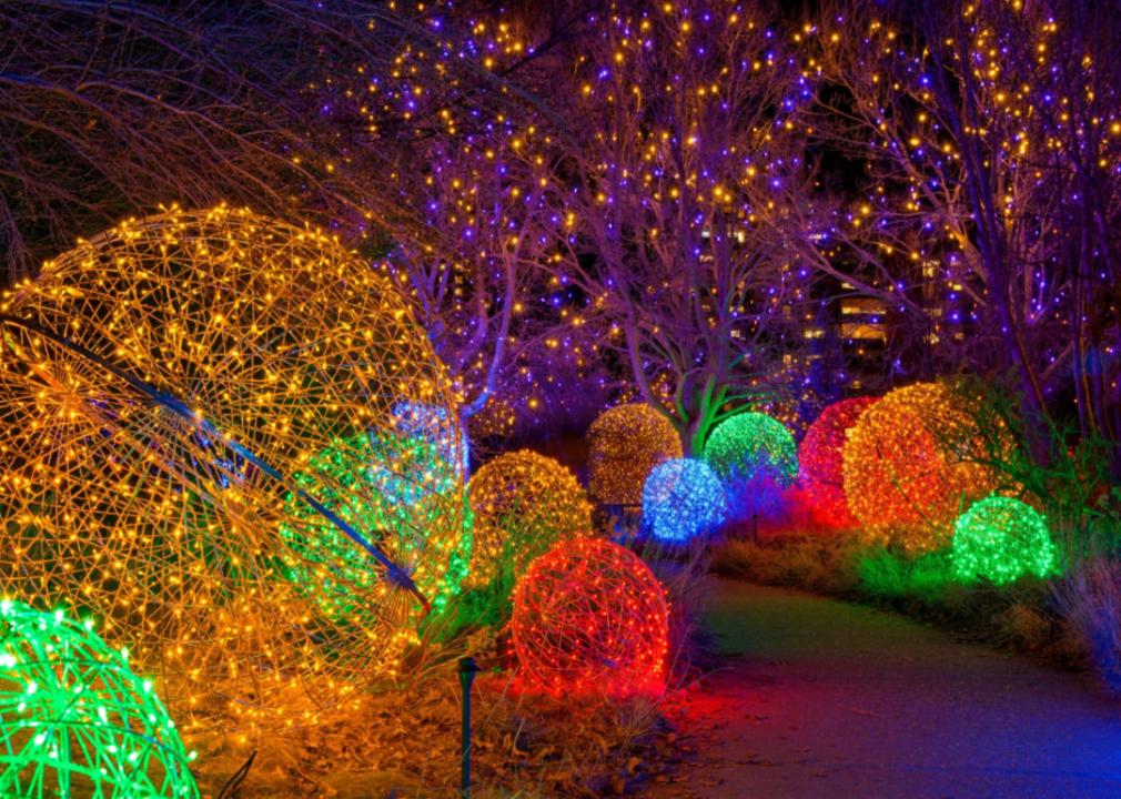 Colorful orbs light a curved pathway.