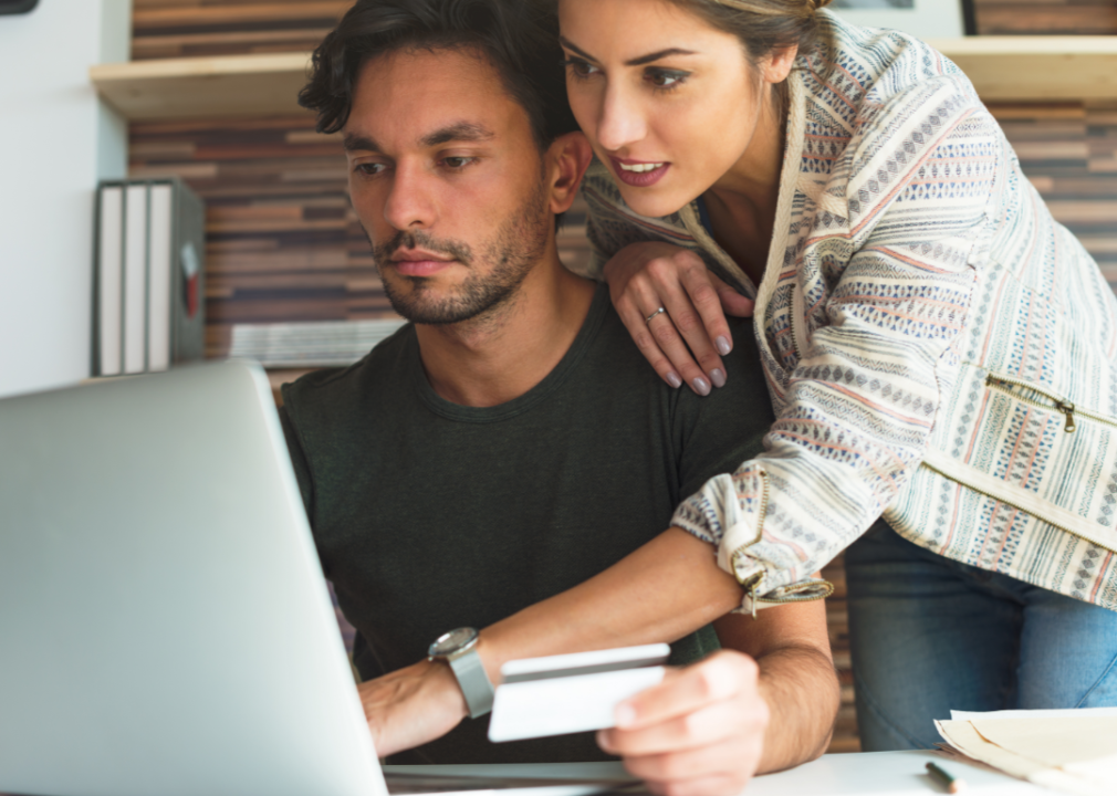 A young man and a young woman study their computer screen