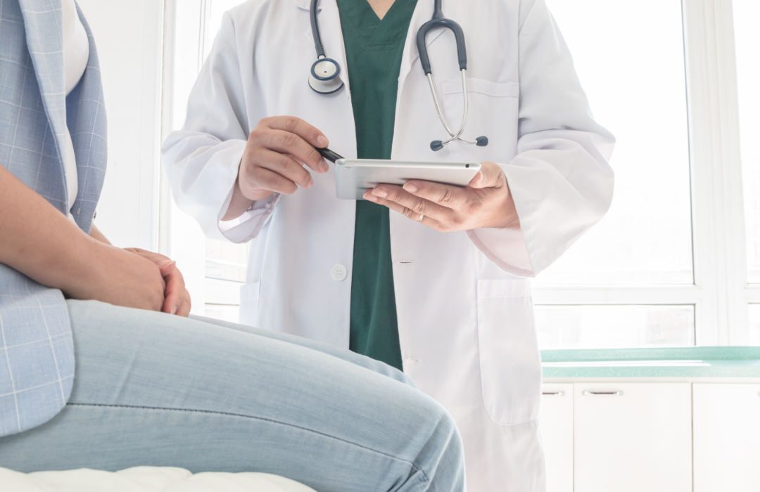 A doctor speaking with a patient in a medical office.