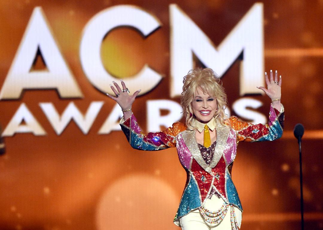Dolly Parton speaking onstage at award event.