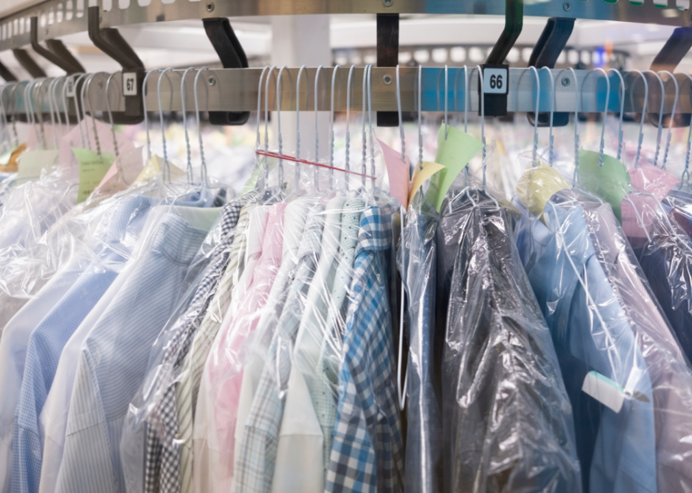 Clothing hanging at a dry cleaner.