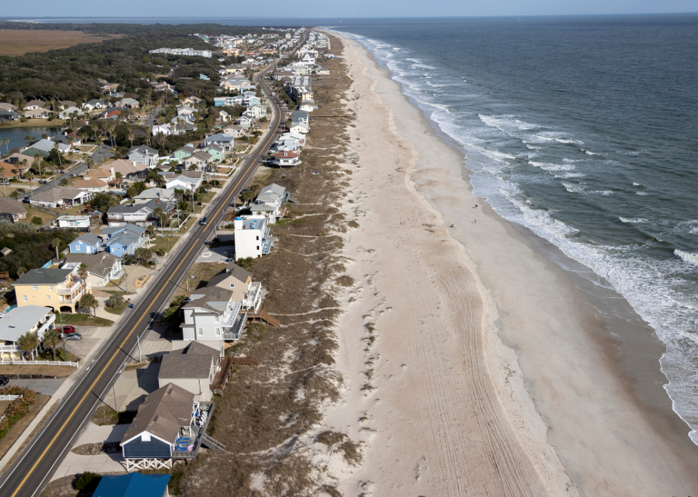 An aerial view of a residential area along the beach.
